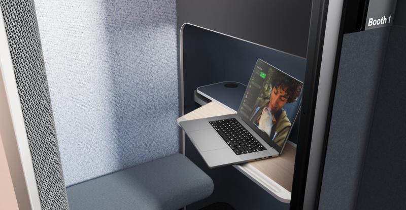 A laptop sits on a table inside the Boeing EnCore E-Lounge booth