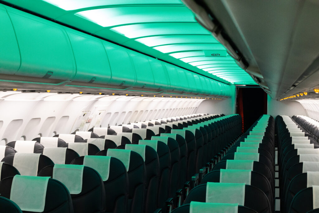 Green mood lighting highlights an empty cabin.