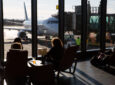 Passengers enjoy views of the ramp in the Paine Field terminal with floor to ceiling windows