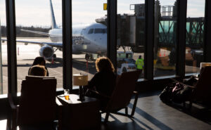 Passengers enjoy views of the ramp in the Paine Field terminal with floor to ceiling windows