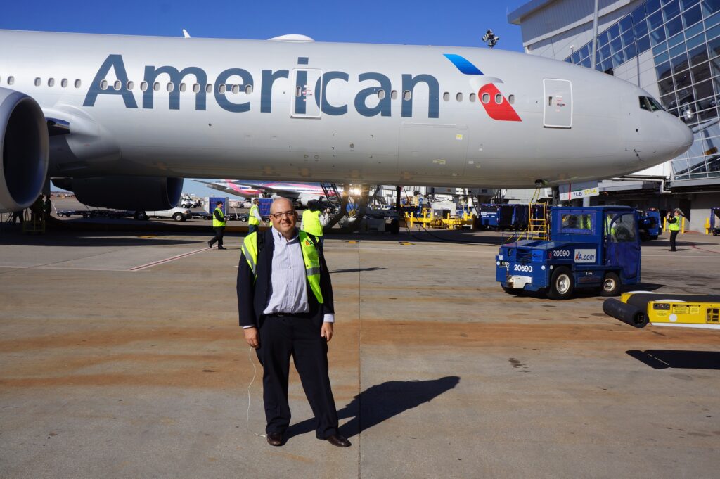 Author Chris Sloan standing in front to the American Airlines Boeing 777-300ER in 2013.