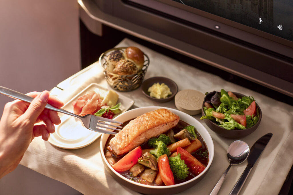 A delectable looking meal is displayed on the tray table in INSIGNIA business class on the 787