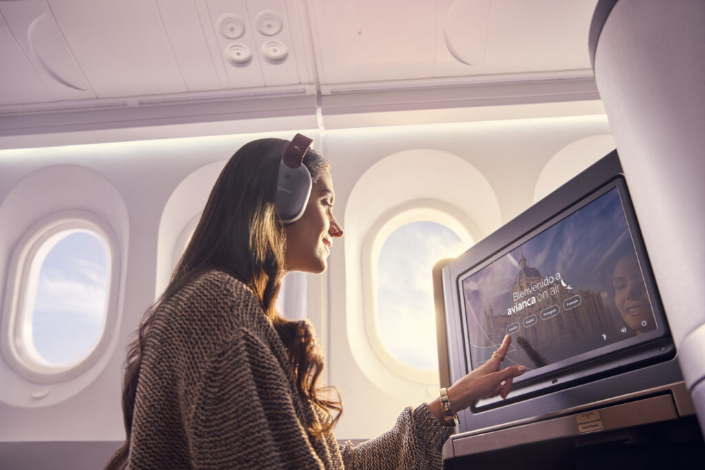 A woman uses the Panasonic IFE whilst seated in Avianca INSIGNIA on the 787