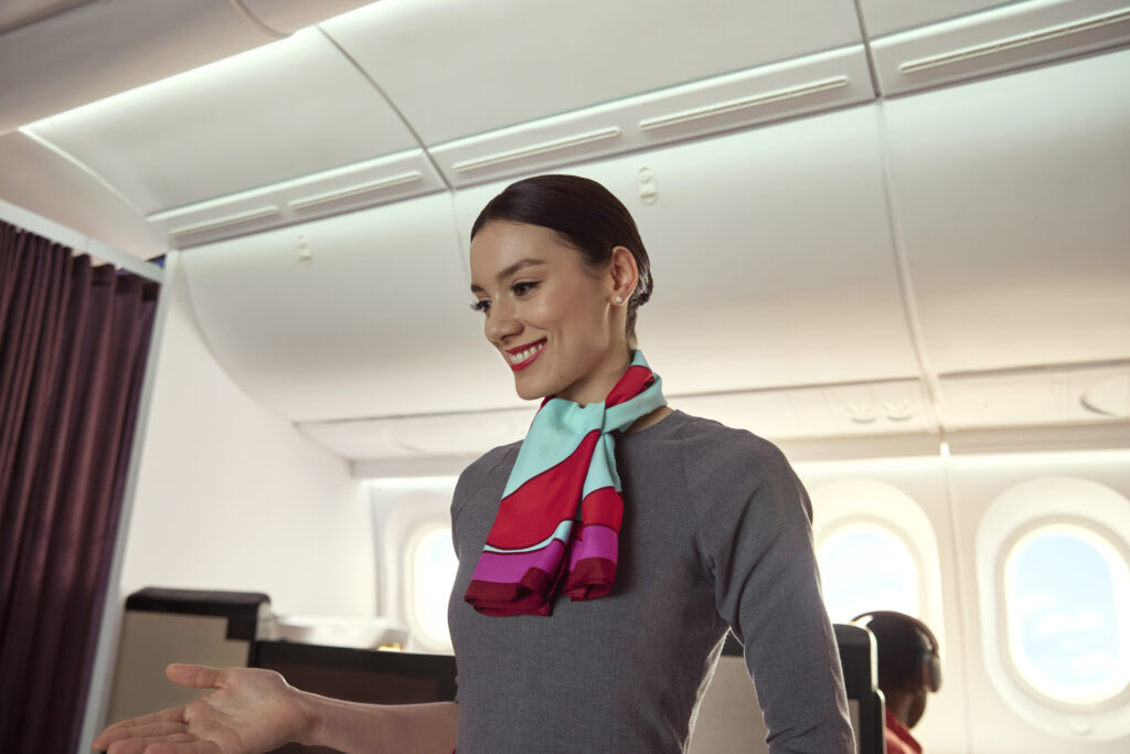 A female crew member greets passengers in INSIGNIA business class on the Avianca 787