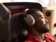 A male passenger enjoys the new INSIGNIA experience with noise-cancelling headphones on the 787