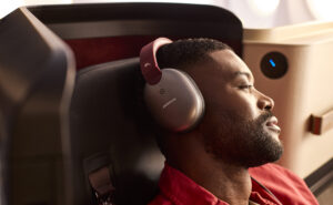 A male passenger enjoys the new INSIGNIA experience with noise-cancelling headphones on the 787