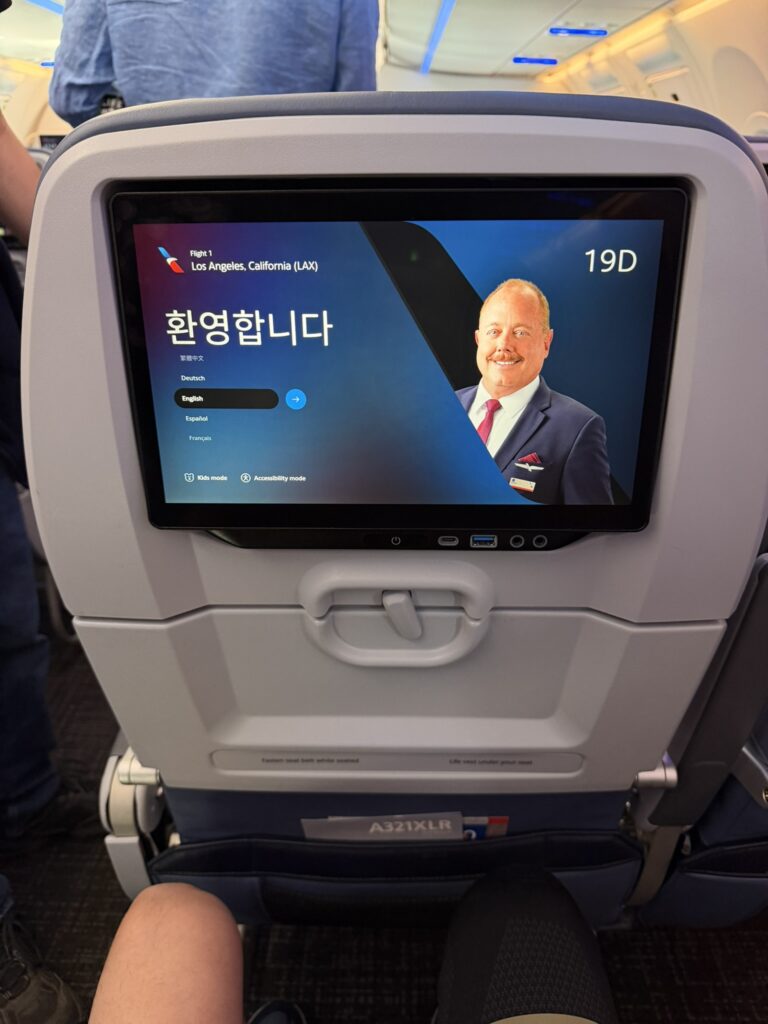 The welcome screen is displayed on the seatback IFE aboard the American A321XLR in Main Cabin