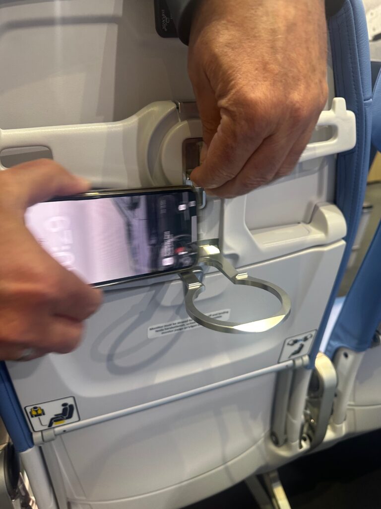 ZIM exec slots his iPhone into the seatback's device holder