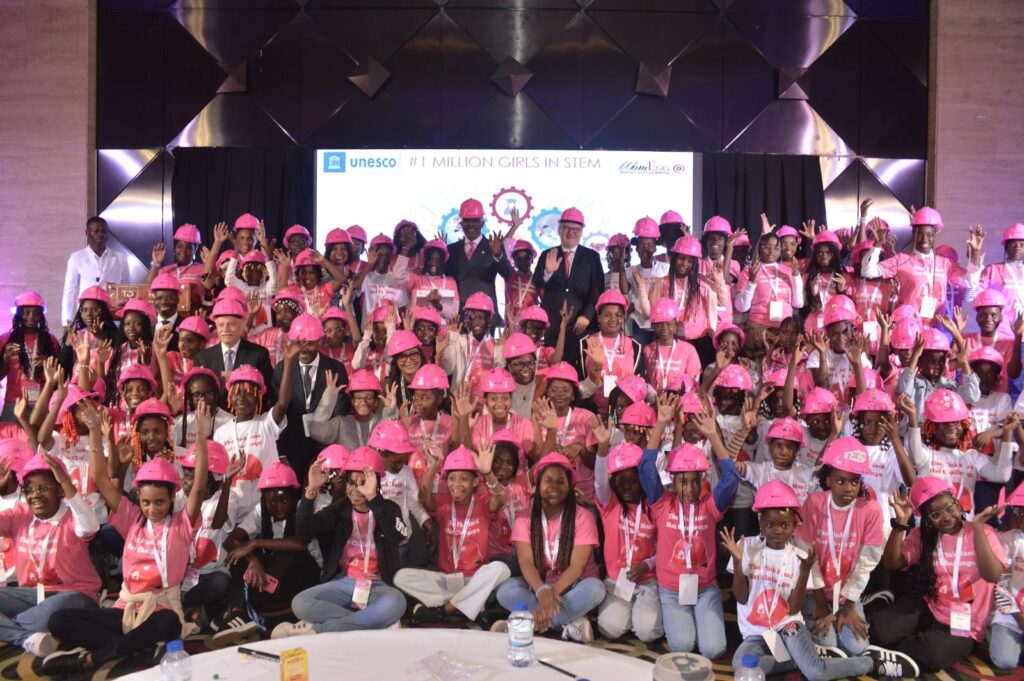 A large group of women at the ICAO Gender Summit are posing for a photo wearing pink.