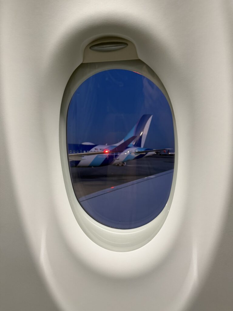 Looking out the window of the JetBlue A220 at the JFK ramp