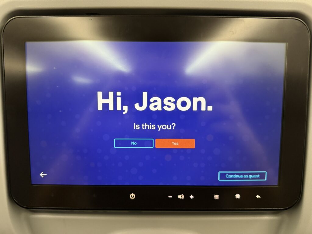 The IFE screen is displaying a welcome screen to the passenger. It says: "Hi Jason"