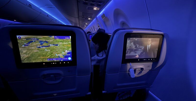 Seatback IFE and blue mood lighting on a JetBlue A220