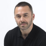 Justin Crabbe is pictured seated, against a white background. He is the CEO & Founder of Jettly, a digital private jet marketplace, and BlackJet, a pre-paid private jet solution.