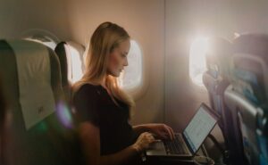 SAS passenger working on their laptop in flight, while using Starlink inflight Wi-Fi.
