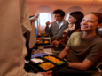 A SWISS passenger is receiving their meal in flight.
