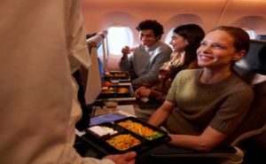 A SWISS passenger is receiving their meal in flight.