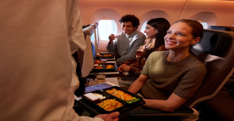 A SWISS passenger is receiving their meal in flight.