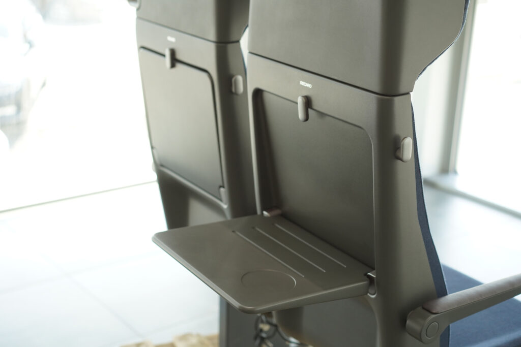 VELA seat with the tray table flipped down