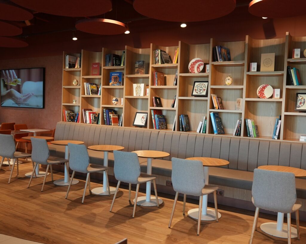 Primeclass lounge dining area flanked by book shelves