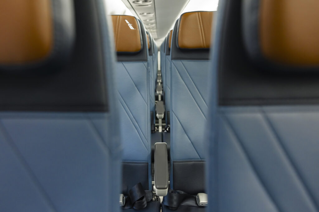 Artistic shot of armrests on the new RECARO seats on board the American Airlines Embraer E175.