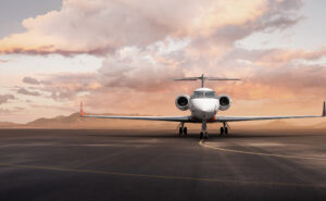 Gulfstream bizjet is parked; a spectacular sky is seen behind it. This is a hero shot of the jet.