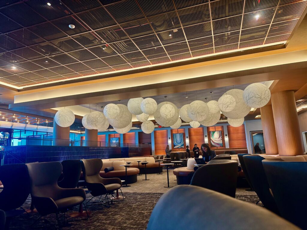 Unique circle-themed lighting fixture over various seats in the United Club