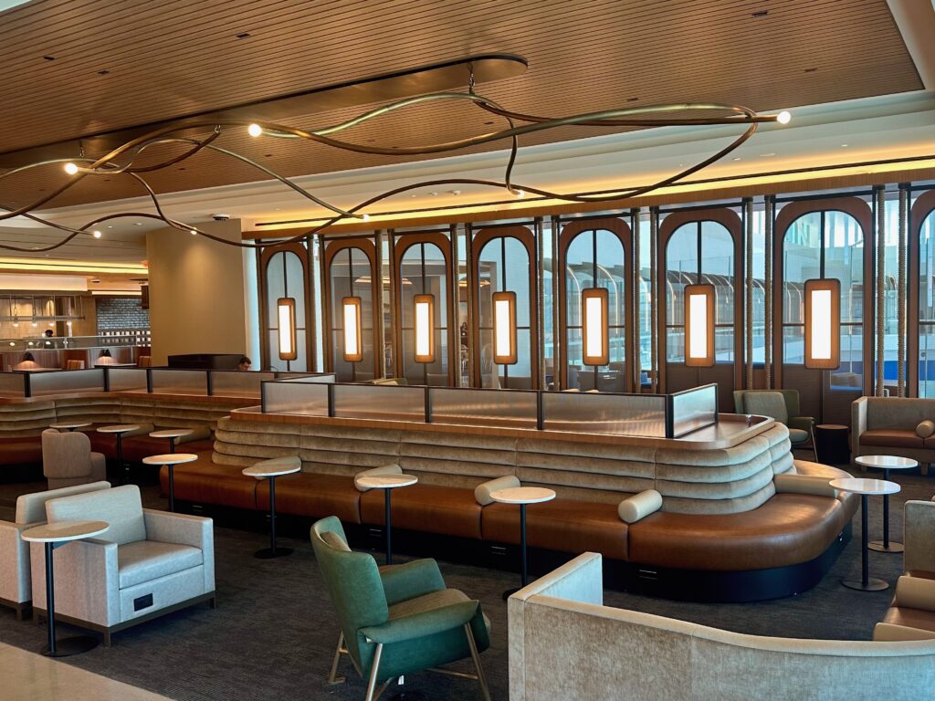 An almost bistro feel to this room, with multiple light fixtures, art fixtures and seating options, plus a large oblong sofa in the middle