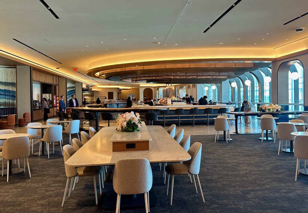 Long tables with chairs, near the large bar.