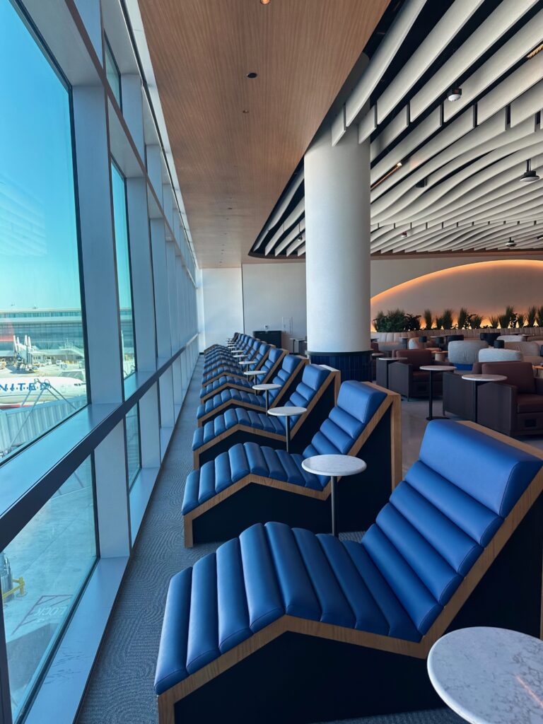 Loungers are positioned near the window to maximize plane spotting