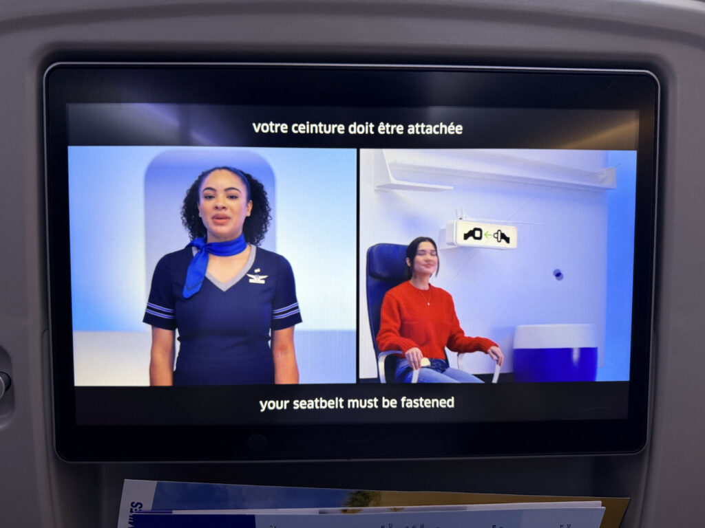 The safety video is playing on the IFE screen.