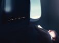 A passenger using their PED onboard the aircraft.
