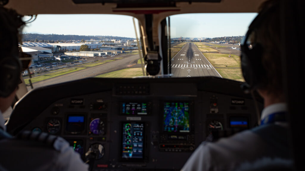Looking out the cockpit windows of the SeaPort Pilatus PC-12 at the runway ahead