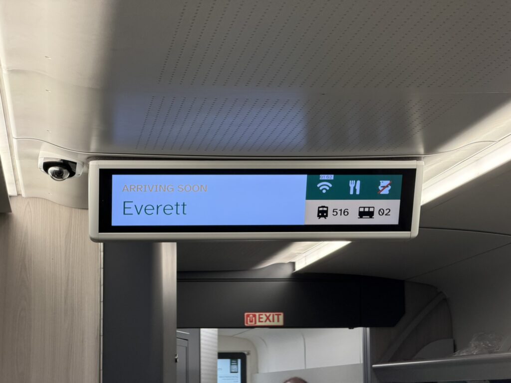 Digital signage on Airo indicates that the trainset is arriving in Everett. There are also symbols to show that Wi-Fi and food are available.