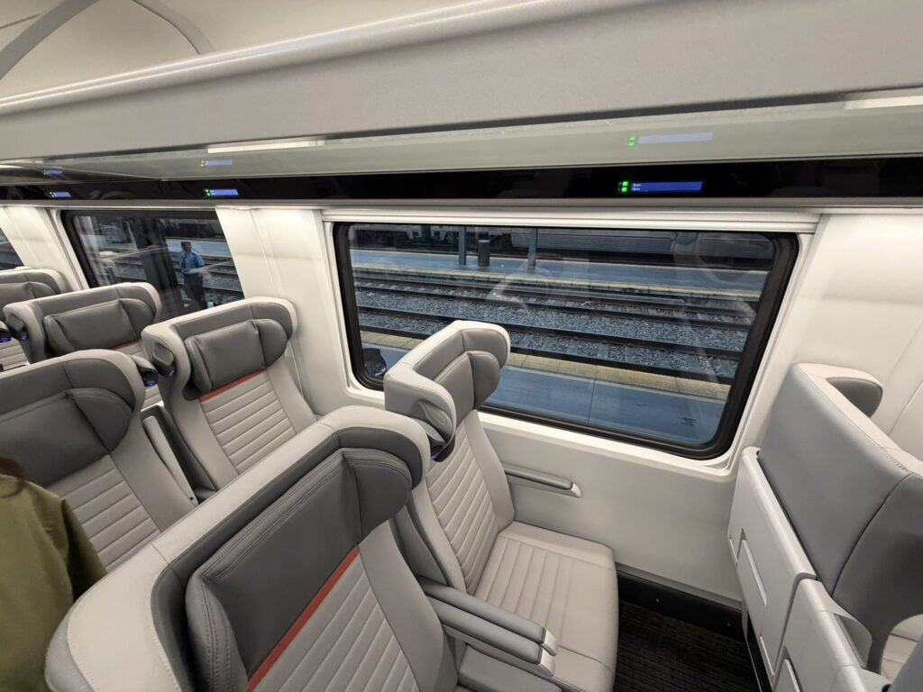 A close up of the headrest on Coach Class seats aboard the Airo trainset