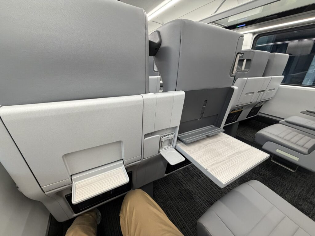 The author relaxes his legs in the reclined Airo Coach Class seat