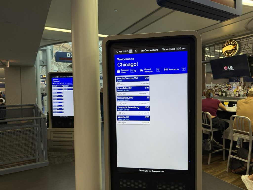 United Airlines connecting flight information on signage at O'Hare.
