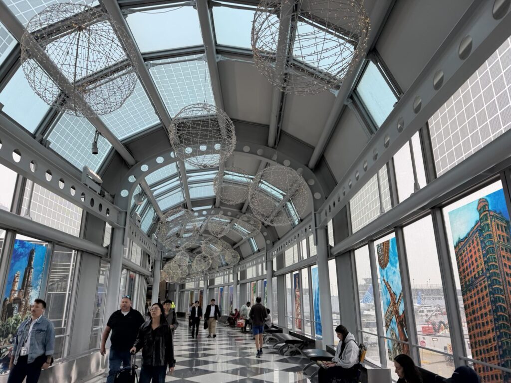 Walking through O'Hare with light streaming in from the windows wrapping around a hall