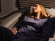 Female passenger aboard the refitted British Airways A380 is in her First suite, relaxing in the new pyjama set