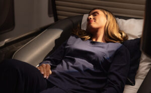 Female passenger aboard the refitted British Airways A380 is in her First suite, relaxing in the new pyjama set