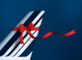 Air France aircraft tail with a red ribbon.